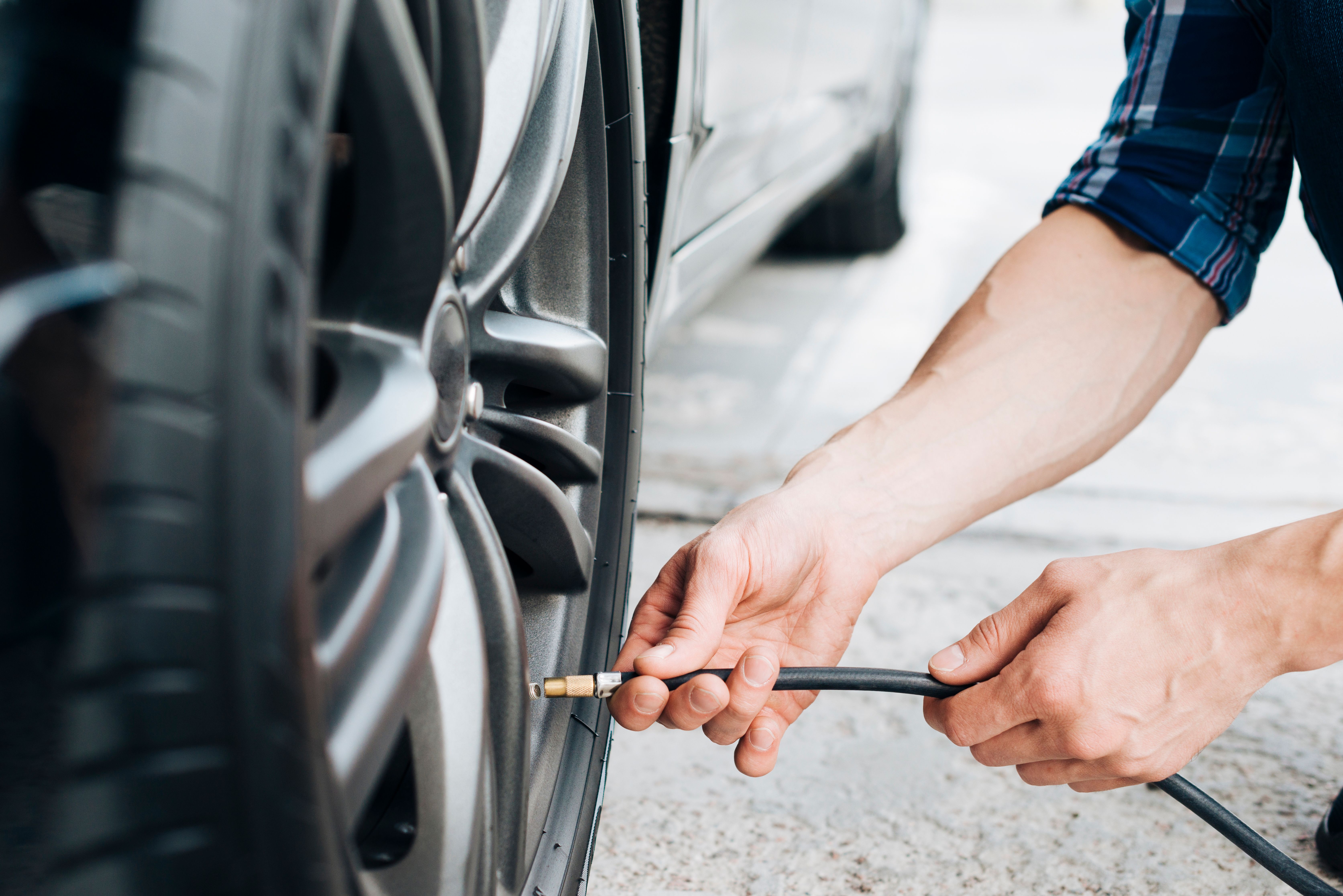 man-using-air-pump-car-wheel.jpg