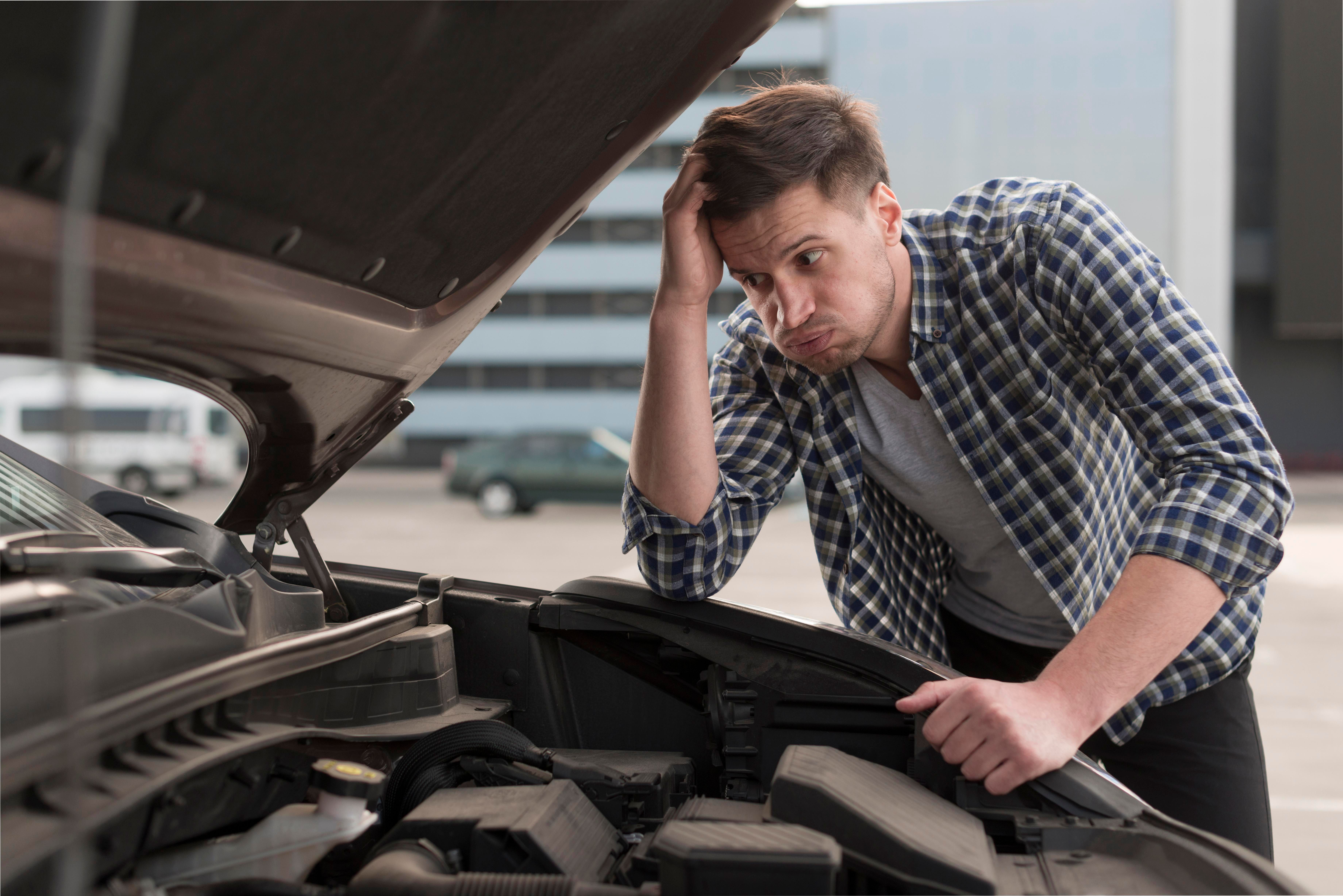 young-man-trying-repair-car.jpg